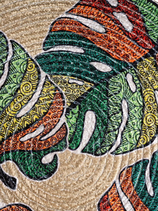 A printed cotton Table mat featuring a leaf design.